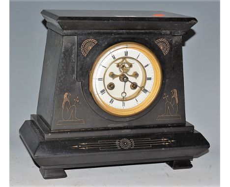 A late Victorian black slate mantel clock, having enamelled chapter ring with Roman numerals and visible escapement, with eig