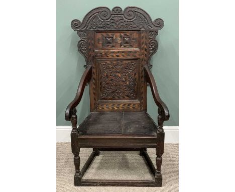 18TH CENTURY OAK WAINSCOTT ARMCHAIR circa 1790, scroll-carved crest and corbels to an inlaid double panel back, blind fretwor