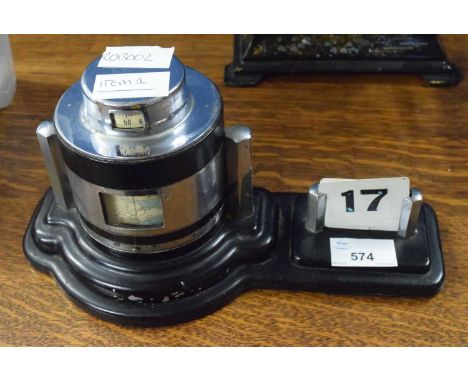 An unusual Art Deco Unigraph chrome mounted desk barometer c. 1930,registered no. 843105, the lid having an inset thermometer