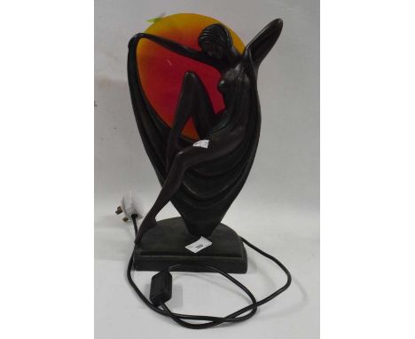 A Art Deco style model of a girl with a lamp in the background, on semi-circular green painted base
