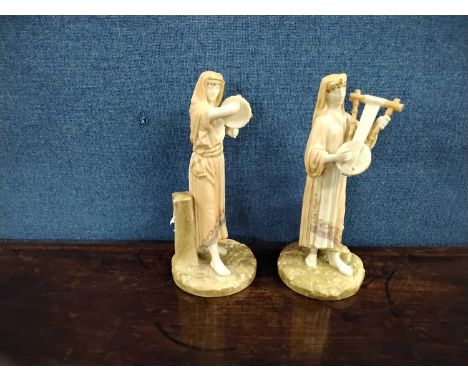 A pair of Royal Worcester Hadley figures of musicians on circular bases, factory mark and shape 1084 to base