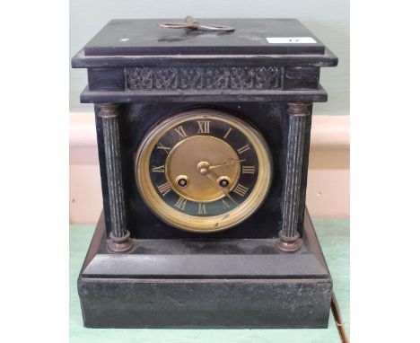 A black slate striking mantel clock