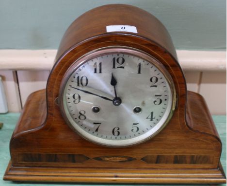 An inlaid walnut striking mantel clock
