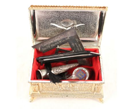 A metal box containing Masonic silver plus other items including an enamelled coin walking stick top