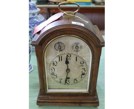 An oak cased striking bracket clock