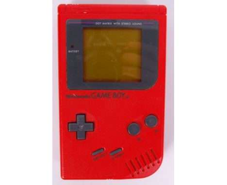 A vintage Nintendo Game Boy console, in red. Battery cover present. Unboxed. Working order.&nbsp;