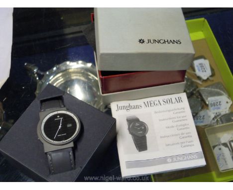 A Junghans Mega solar gentleman's watch with a black face and strap, boxed.
