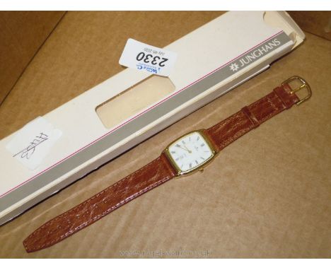 A German Junghans Quartz bracelet watch with brown strap, boxed.