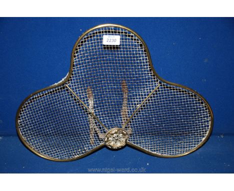 A shaped brass fireguard with central Tudor rose decoration