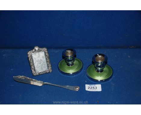 A pair of Guilloche enamel candlesticks, 1904 Birmingham silver frame and 1912 Sheffield silver knife.