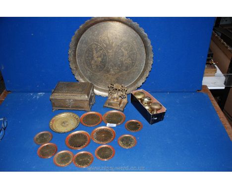 A quantity of brass including circular tray with scalloped edges, set of graduated coasters, Art Deco candlestick, door knobs