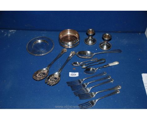 A quantity of silver plate including wine bottle coaster, candlestick, spoons, etc.