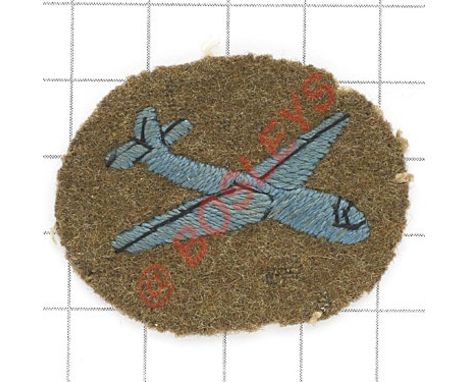 Glider-Borne Troops, Airborne Forces WW2 cloth arm badge. Blue glider embroidered on felt khaki oval.  Removed from uniform. 