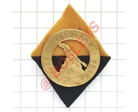 Nyasaland Defence Force WW2 brass cap badge. Finely cast circular example on a yellow over black horizontally halved felt dia