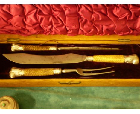 AN OAK BOXED CARVING SET WITH KNIFE, FORK (MISSING GUARD), STEEL WITH SILVER MOUNTED "HORN" HANDLES BY ALPHA ?SHEFFIELD 1938 