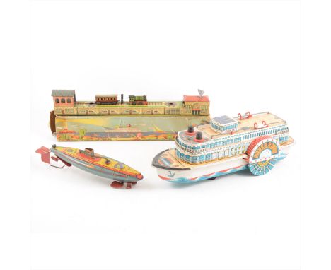 Tin-plate toys; three including German clock-work train line with engine shed, boxed, a J187 HMS Nautilus submarine, 26cm, Mo