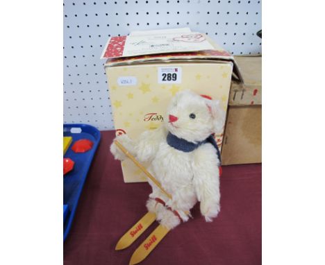 A Steiff Teddy Bear 'Skier', limited edition No 218/1500, white mohair body, hat, scarf, wooden Steiff skis, measuring 18cm t