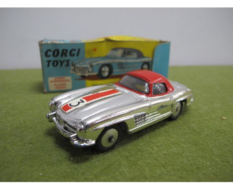 A Boxed Corgi Toys No. 304S Mercedes Benz 300SL Hard Top Roadster, chrome body, red hard top, chipping/rubbing to paint work,