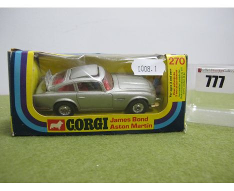 A Corgi Toys No 270 Diecast Model James Bond Aston Martin, two Bandit figures present, slight crushing and small tear to pict