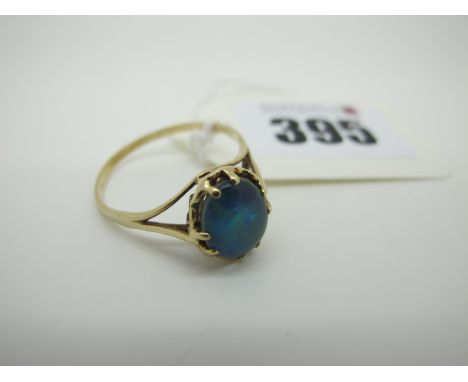 A Black Opal Doublet Single Stone Ring, oval claw set (finger size W). 