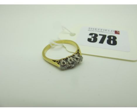 A Three Stone Diamond Ring, claw set with old cut stones stamped "18ct" (finger size M) (2.5grams). 