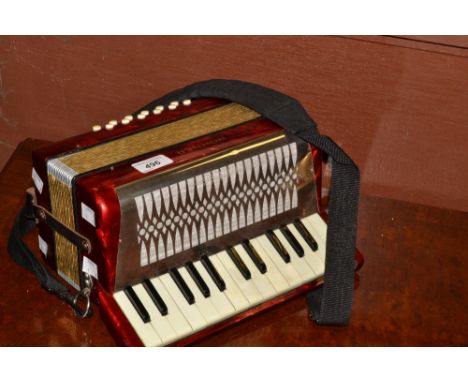A German Hohner piano accordion in red and chrome