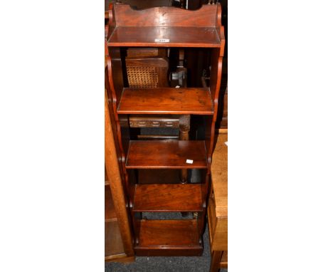 A mahogany four tier wall mounting shelf, narrow body, shaped top