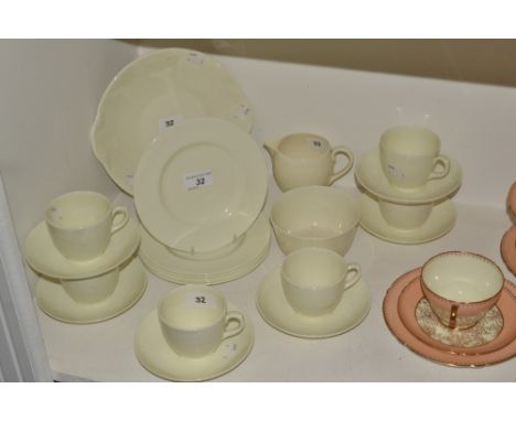 A Royal Doulton tea set for six, ivory ground, comprising bread plate, milk and sugar, teacups,  saucers, green printed marks