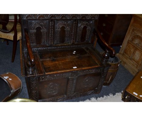 A late 19th Century heavily carved  oak monks bench C.1890 