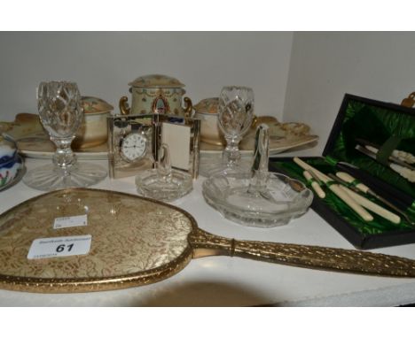 An early 20th century Adams dressing table set, enamelled and gilded on an ivory ground with ribbons and swags, comprising re