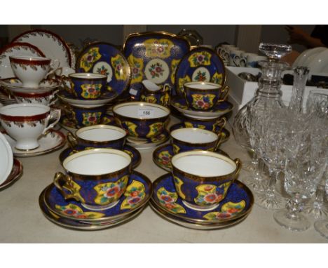 A Noritake tea service for eight, each printed with flowers on a blue ground