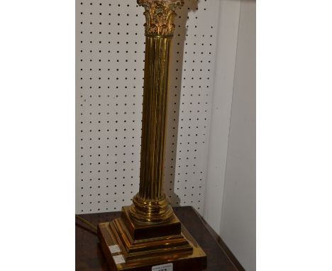 A brass table lamp fashioned as a Corinthian column, stepped square socket and base.