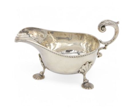 Edwardian silver sauce boat, of typical form with personal engraving to underside, oblique gadrooned rim and acanthus capped 