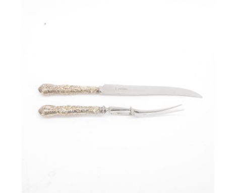 Late 20th century silver handled carving knife and fork pair, the silver handles profusely embossed with fruiting vines, hall
