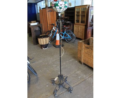 Metal scroll decorated standard lamp, Tiffany style shade.