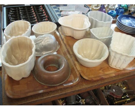 Two trays of ceramic copper and tin jelly moulds of various forms.  (2)