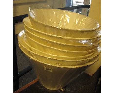Seven cream pleated lamp shades, as new, in cellophane. (7)
