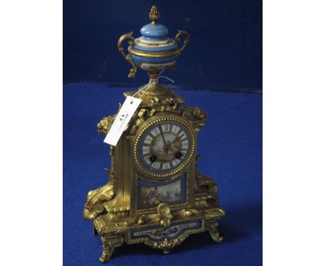 19th Century French gilt spelter, porcelain mounted, two train architectural mantle clock with urn shaped finial and brass dr