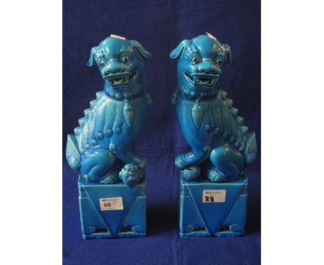 Pair of Oriental blue glazed ceramic Dogs of Fo, temple dogs on matching rectangular plinths. (2)
