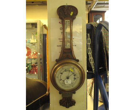 Early 20th Century carved oak presentation aneroid wheel barometer.