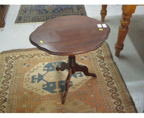 Modern mahogany oval shaped pedestal wine table on triform base. 