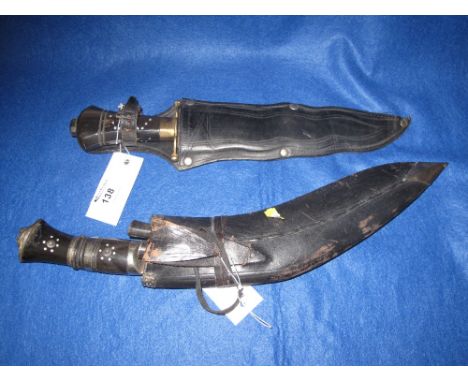 Indian Kukri in leather scabbard with two small knives together with another Indian knife with waved edge blade in leather sc