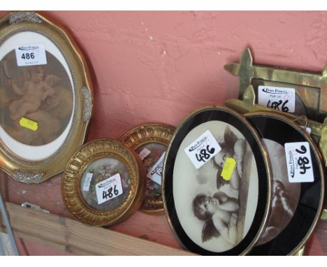 Group of small framed furnishing pictures including cherubs, foliate studiesand a pair of portrait photographs in brass trenc