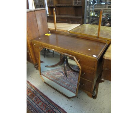 Mid 20th Century oak carved mirror backed dressing-table on bracket feet.