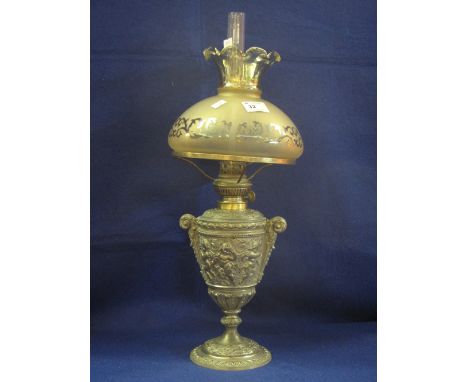 White metal Rococco style urn shaped lamp base with relief foliate and figural decoration, etched glass shade and clear chimn