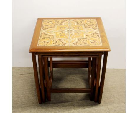 A nest of three 1970's G-plan teak coffee tables, top table inset with ceramic tiles, 50 x 50 x 50cm.