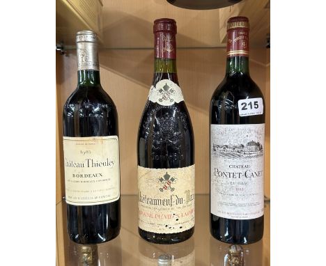 Three bottles of vintage red wine.