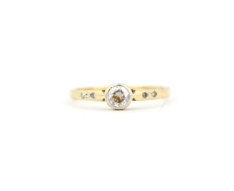 An 18ct yellow gold ring set with an old brilliant cut Diamond with diamond set shoulders, (K).