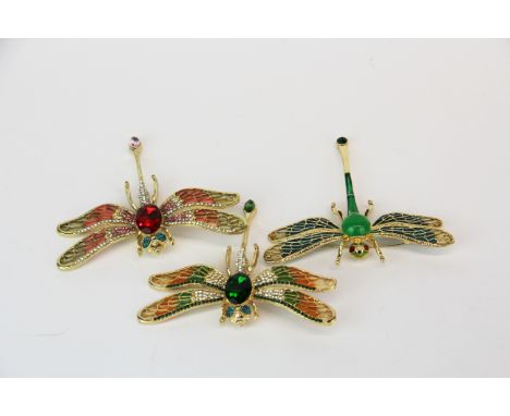 Three gold plated and enamel costume jewellery dragonfly brooches.