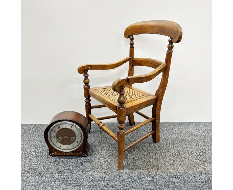 A 19th Century cane seated child's potty chair with hinged seat, H. 62cm. Together with an oak mantle clock.